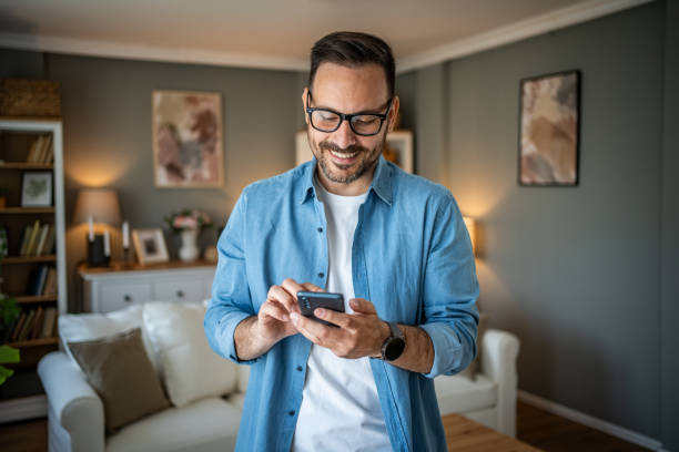 istock Portrait of cheerful man using smartphone to read messages or scroll through social networks, daily routine 2170511022