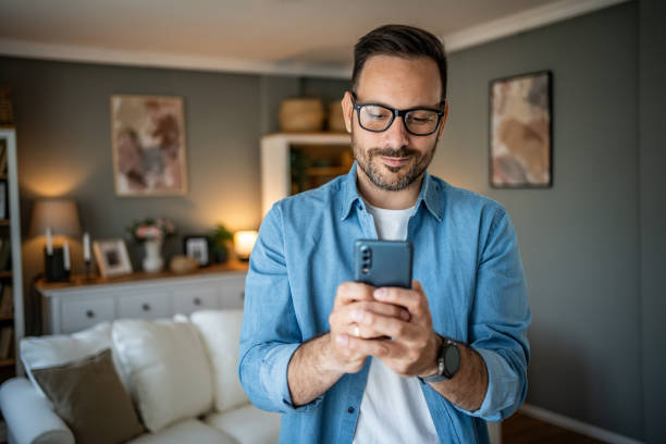 istock Portrait of cheerful man using smartphone to read messages or scroll through social networks, daily routine 2170511024
