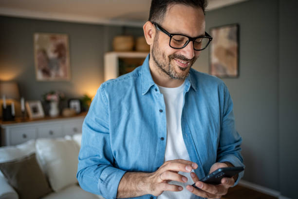 istock Portrait of cheerful man using smartphone to read messages or scroll through social networks, daily routine 2170511054