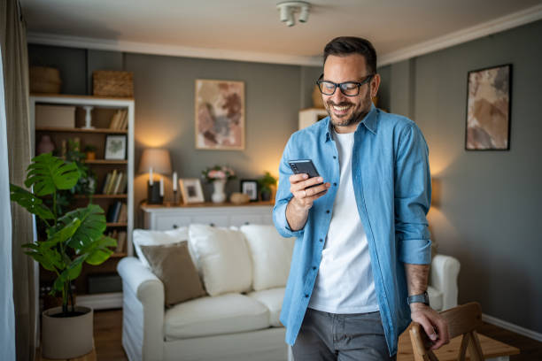 istock Portrait of cheerful man using smartphone to read messages or scroll through social networks, daily routine 2170511063