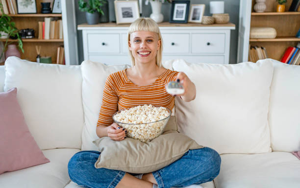 istock Woman is watching TV at home 2170515726