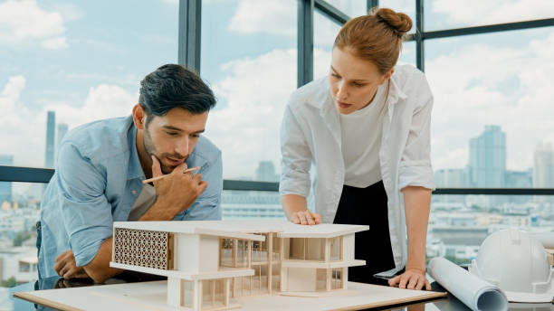 istock Cooperative engineer team working together to measure house model. Tracery 2170522241