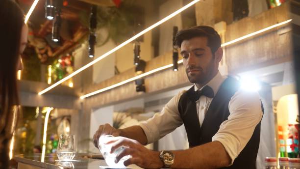istock Focusing bartender serving soda with customer at back view at bar. Vinosity. 2170522511