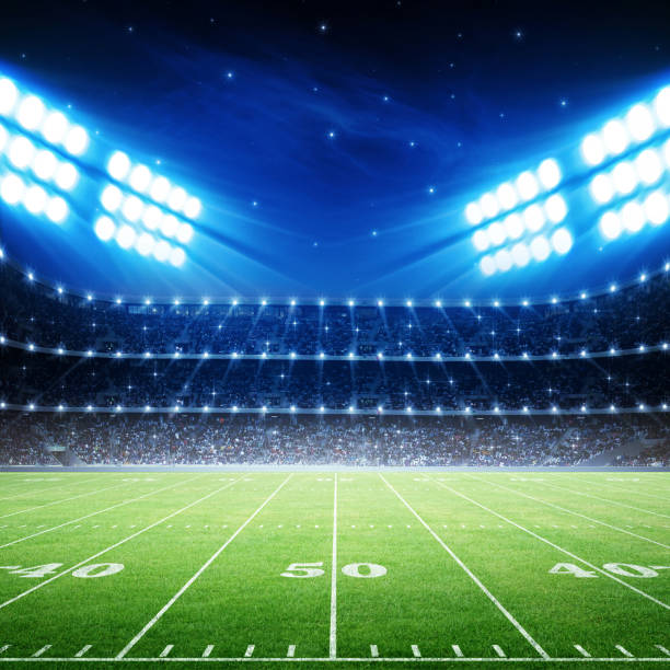 istock IIIuminated American Football Stadium at night with empty field. 2170524573
