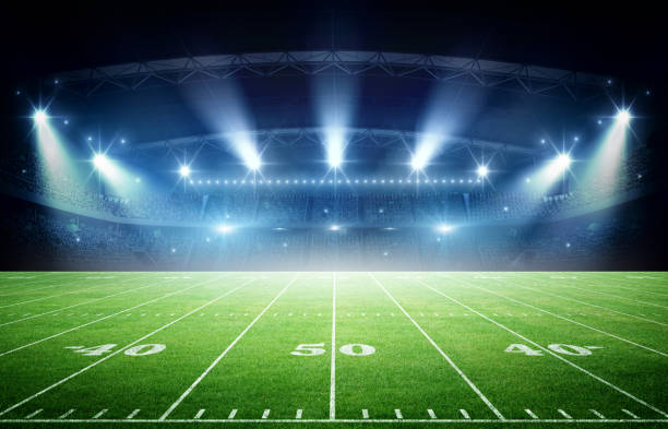 istock IIIuminated American Football Stadium at night with empty field. 2170524720