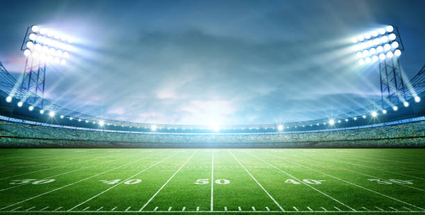 istock IIIuminated American Football Stadium at night with empty field. 2170524721