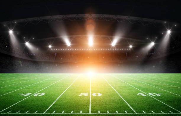 istock IIIuminated American Football Stadium at night with empty field. 2170524786