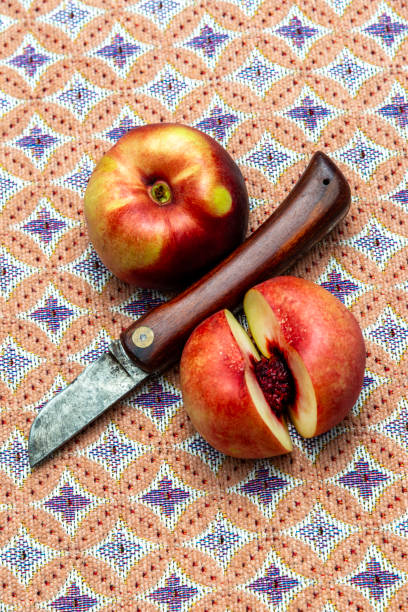 Nectarine on a linnen textured background. High angle view, studio shot.
