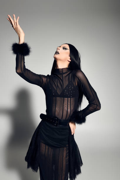 istock A glamorous drag queen in a striking black ensemble poses artfully against a gray backdrop 2170526026