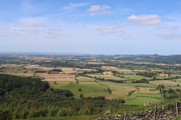 istock View over rolling countryside with fields and woodland in the summer 2170528051