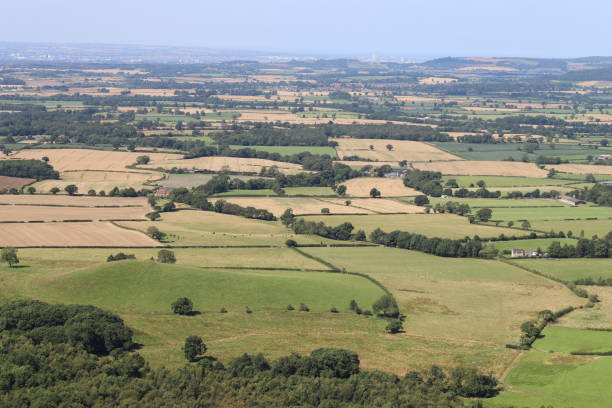 istock View over rolling countryside with fields and woodland in the summer 2170528219