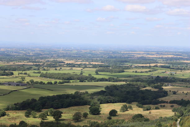 istock View over rolling countryside with fields and woodland in the summer 2170530777
