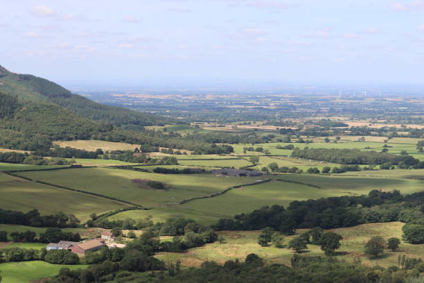 istock View over rolling countryside with fields and woodland in the summer 2170530852