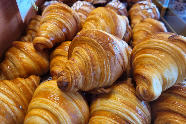 istock Freshly baked croissants in bakery store close up 2170531304