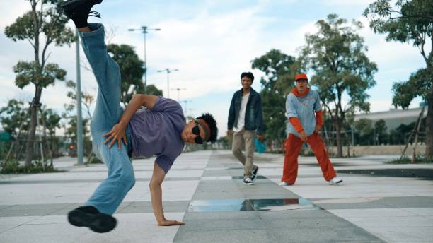 istock Attractive dancer perform break dance in front of friend cheering. Sprightly. 2170535583