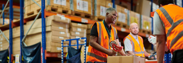 istock senior warehouse worker chatting to colleague 2170536656