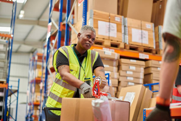 istock senior warehouse worker chatting to colleague 2170536951