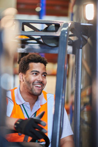 istock fork lift operator chatting to colleague 2170537153