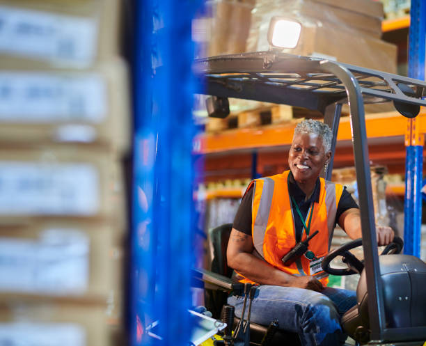 istock senior female fork lift operator chatting to colleague 2170537419