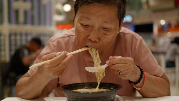 istock Happy Senior woman eating ramen. 2170539632