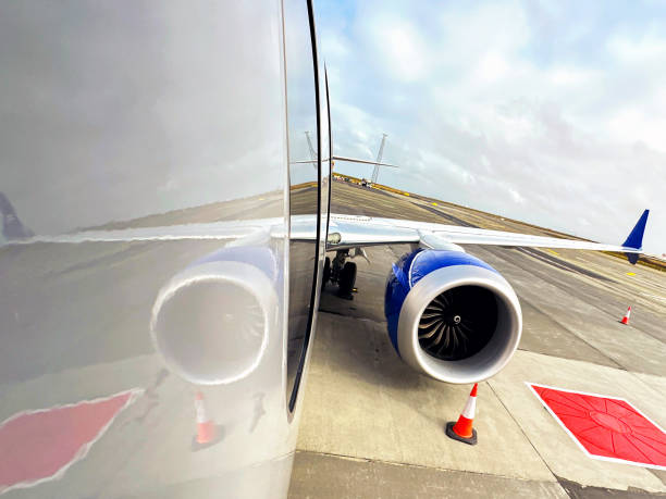 istock Aircraft engine and wing of a passenger jet reflected in its fuselage. 2170540523