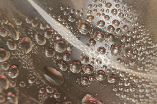 istock Close up of water droplets condensed on a surface 2170542343