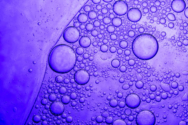 Purple macro science bubble texture,the bubbles spheres are grouped together to form different patterns. and some are scattered around on a gradation purple background It looks scientific,