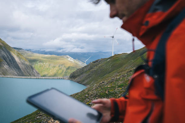 istock Backpacker uses digital tablet above alpine lake 2170544128