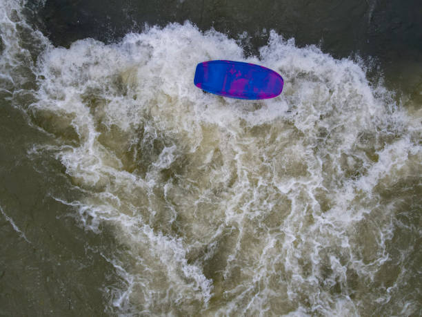 Munich, Germany - April 7, 2009: surfer surfs at the Isar in huge waves for season opening event at the Wittelsbacher bridge in the heart of Munich, Germany.