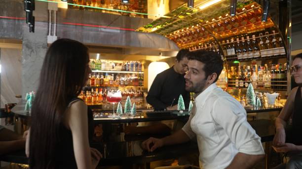 istock Guest siting fronted bar discussing with friend waiting for drinks. Vinosity. 2170544875