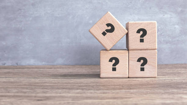 istock Wooden Cube with Question Mark Symbol on wooden table. 2170545617