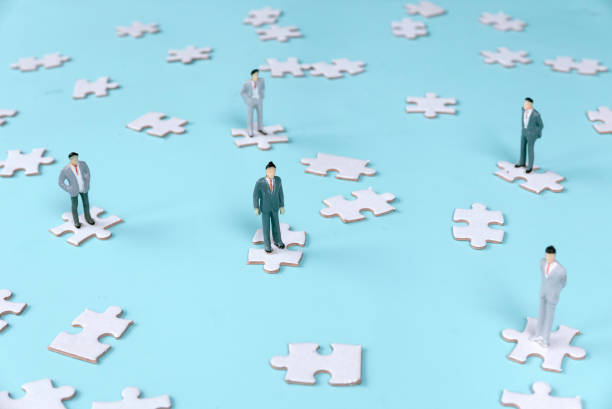 istock Five Businessmen Standing on Separate Jigsaw Puzzle Pieces: Illustrating Distinct Roles and Coordination Challenges 2170545679