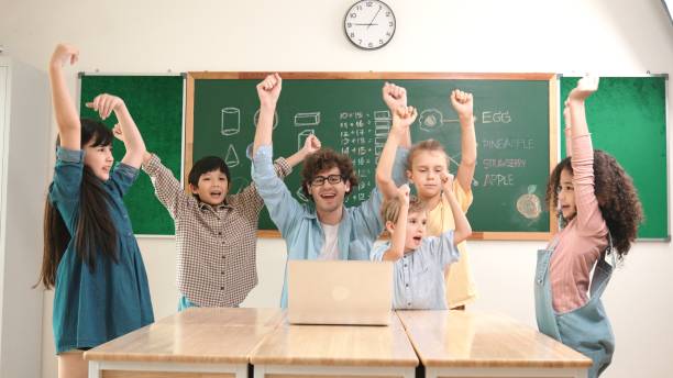 istock Teacher and student looking at laptop while celebrate success project. Pedagogy. 2170547758