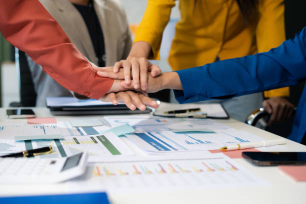 istock Close up business people holding each others wrists, join hands together, support and unity, team strength and power, colleagues involved in team building activity. 2170553440