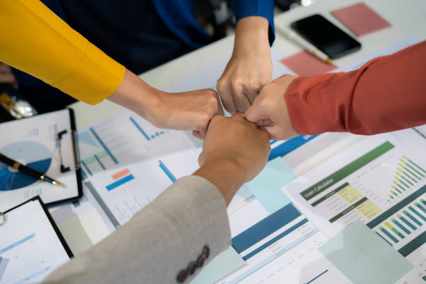 istock Close up business people holding each others wrists, join hands together, support and unity, team strength and power, colleagues involved in team building activity. 2170553447