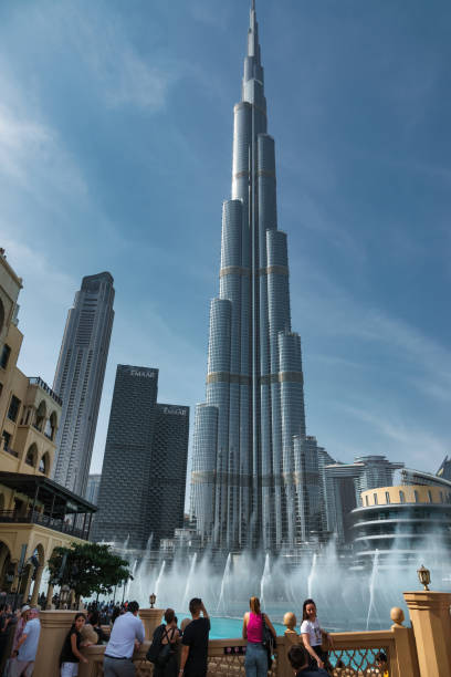 People take pictures at the landmark Burj Khalifa in Dubai, United Arab Emirates on a sunny day.