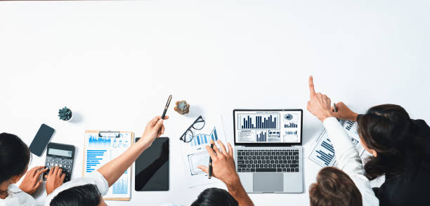 istock Businesspeople on meeting table pointing to empty space. Prudent 2170558967