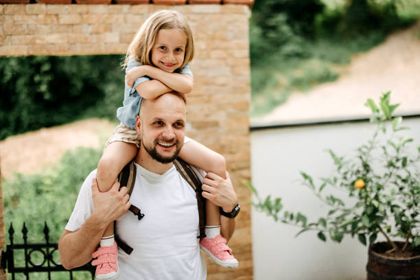 istock Father carries his daughter on his shoulders 2170560299