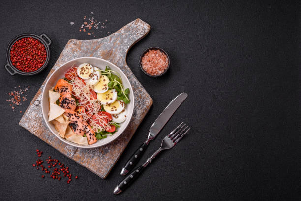 istock Delicious fresh caesar salad with salmon, lettuce, tomatoes and egg 2170562290