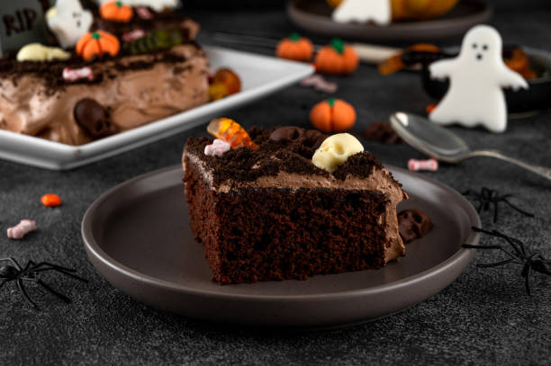 istock Halloween chocolate cake. Dirty cake with chocolate cream, decorated with worms, skulls, ghosts, pumpkins and sugar sprinkles on a dark background. 2170564986