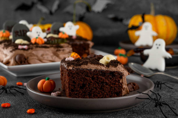 istock Halloween chocolate cake. Dirty cake with chocolate cream, decorated with worms, skulls, ghosts, pumpkins and sugar sprinkles on a dark background. 2170564991