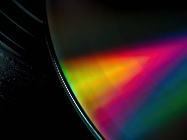 istock Closeup of CD-rom disk on black vinyl record 2170565509