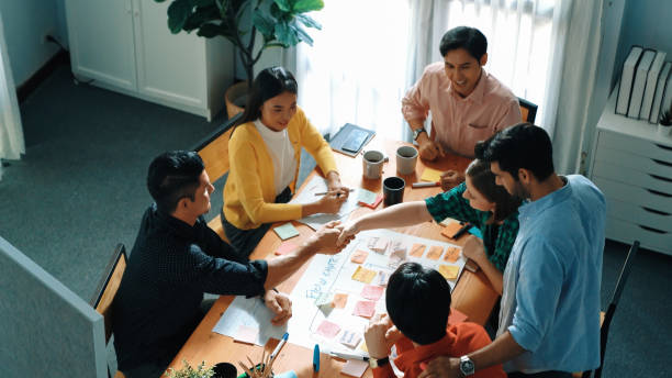 istock Top view of diverse smart people making task board and shake hands. Convocation. 2170566171