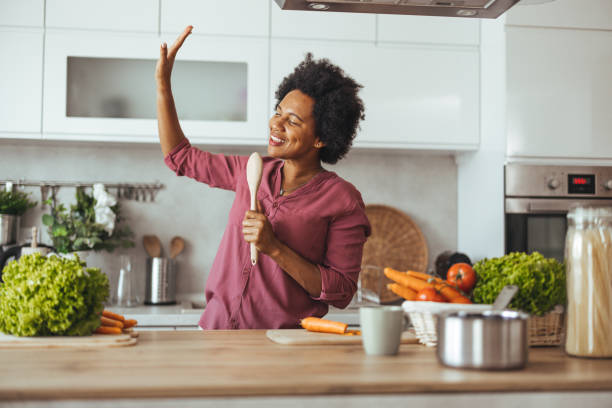 istock Happy Woman Singing and Cooking in Modern Kitchen 2170566959