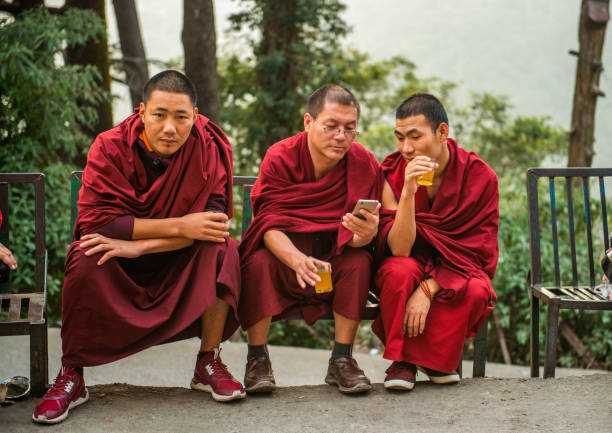 Dharmshala, Himachal Pradesh, India - October 31, 2017 :Three monks relaxing and enjoying local tea in McLeodganj.