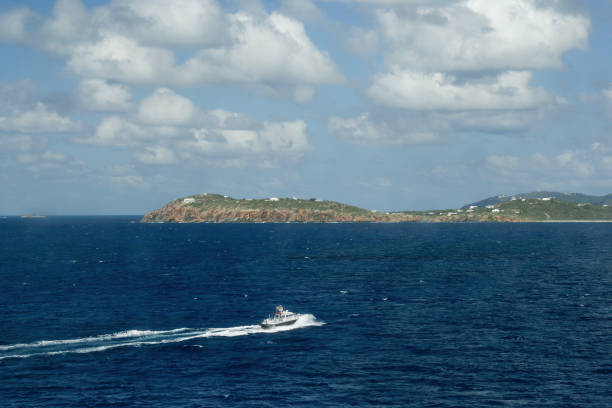 St. Thomas, US Virgin Islands - February 26, 2006: A pilot boat assist with guiding a cruise ship into port in St. Thomas