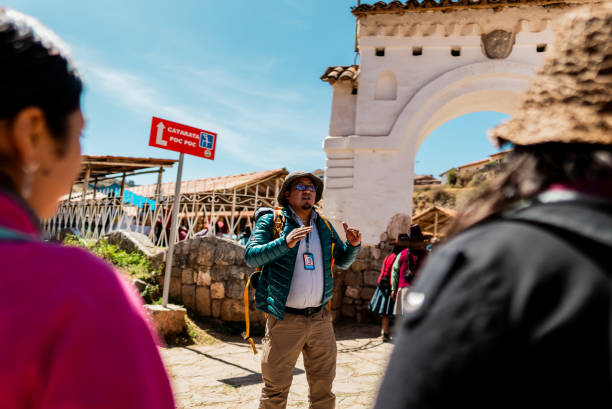 istock Tour guide talking with tourist on Chinchero district, Peru 2170572048