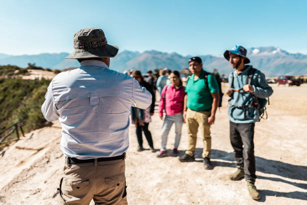 istock Tour guide talking with tourist on mountain, in Moray, Peru 2170572230