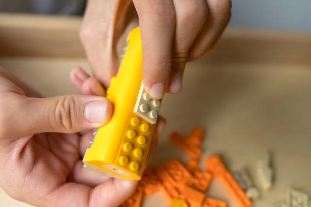 Kids' Creative Building Material. Learning concept. Toy construction set. Building blocks in child's hand.