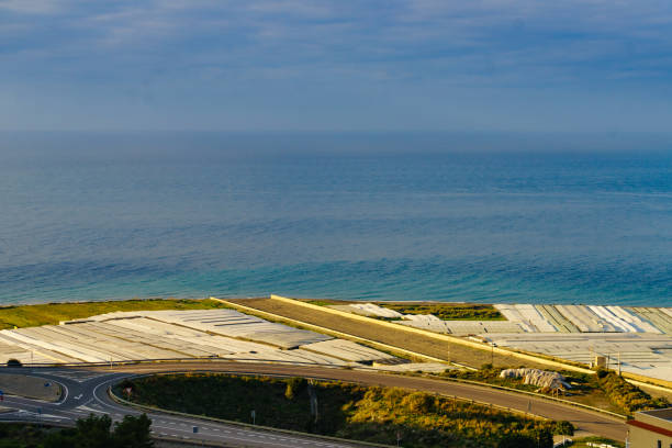 Spanish landscape and view of sea coast with many plastic greenhouses. Almeria region, Andalusia